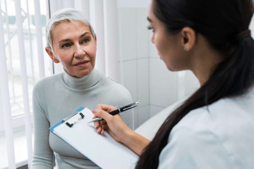 Dentist discussing oral health concerns with a patient during a one-on-one dental consultation