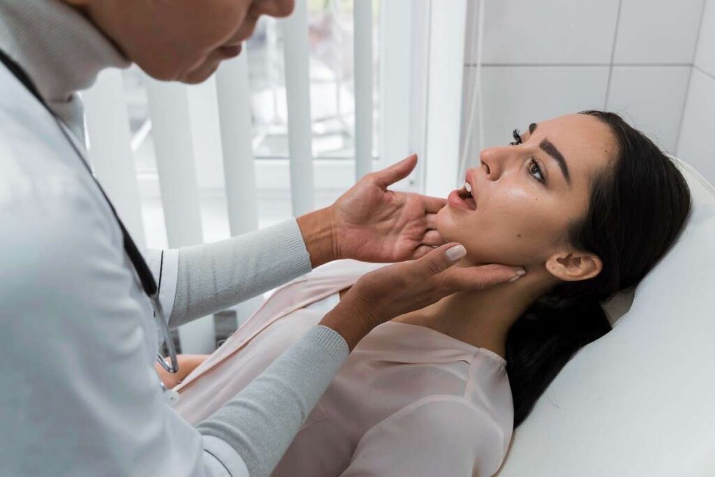 Dentist examining a patient’s jaw and mouth during a routine dental checkup in a clinic